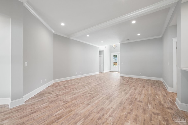 empty room with ornamental molding and light wood-type flooring