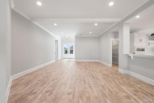 unfurnished living room with french doors, light hardwood / wood-style floors, and crown molding