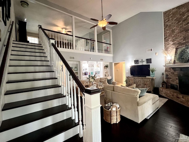 39 Blithewood Dr, Pensacola, FL 32514 - living area featuring high vaulted ceiling, a ceiling fan, stairs, wood-type flooring, and a brick fireplace