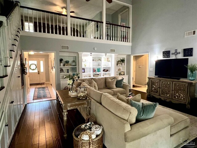 39 Blithewood Dr, Pensacola, FL 32514 - living room featuring a towering ceiling, dark wood-type flooring, plenty of natural light, built in shelves, and ceiling fan