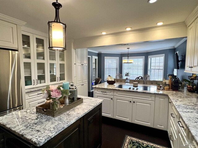 39 Blithewood Dr, Pensacola, FL 32514 - kitchen featuring freestanding refrigerator, a peninsula, glass insert cabinets, white cabinetry, and ornamental molding