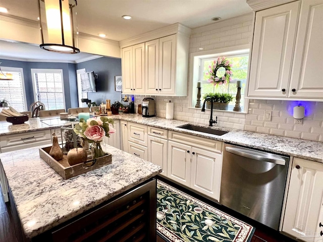 39 Blithewood Dr, Pensacola, FL 32514 - kitchen with stainless steel dishwasher, a sink, crown molding, a center island, and decorative backsplash