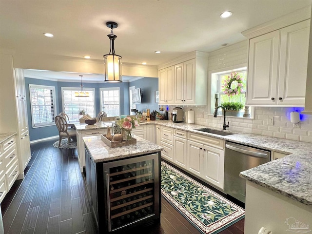 39 Blithewood Dr, Pensacola, FL 32514 - kitchen featuring wine cooler, a sink, stainless steel dishwasher, a peninsula, and white cabinetry
