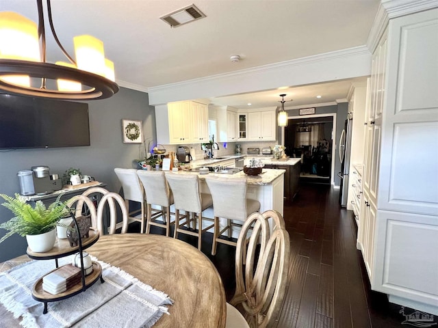 39 Blithewood Dr, Pensacola, FL 32514 - dining room with crown molding and dark wood-style floors