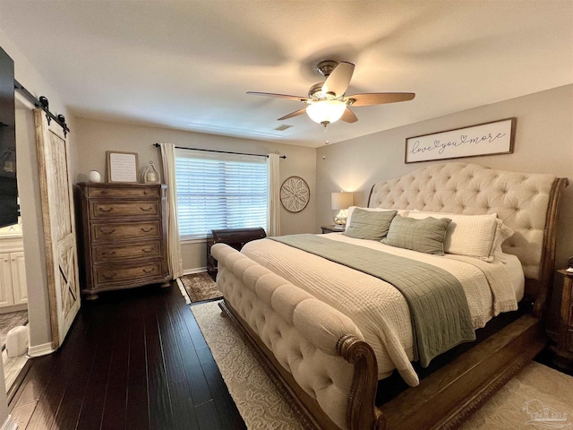 39 Blithewood Dr, Pensacola, FL 32514 - bedroom with a barn door, wood-type flooring, a ceiling fan, and baseboards