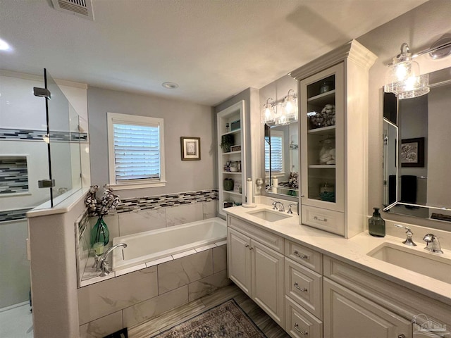 39 Blithewood Dr, Pensacola, FL 32514 - full bathroom featuring a garden tub, double vanity, a shower with door, and recessed lighting