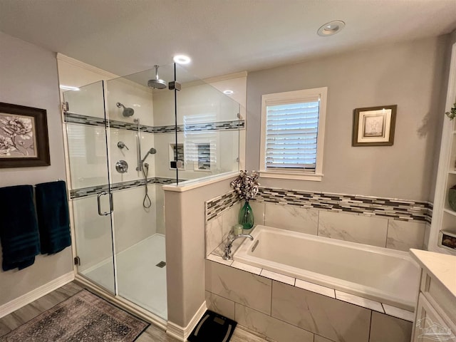 39 Blithewood Dr, Pensacola, FL 32514 - full bathroom with a stall shower, a bath, wood finished floors, and vanity