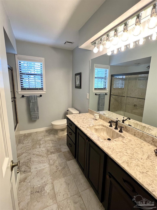 39 Blithewood Dr, Pensacola, FL 32514 - bathroom featuring vanity, toilet, plenty of natural light, and baseboards