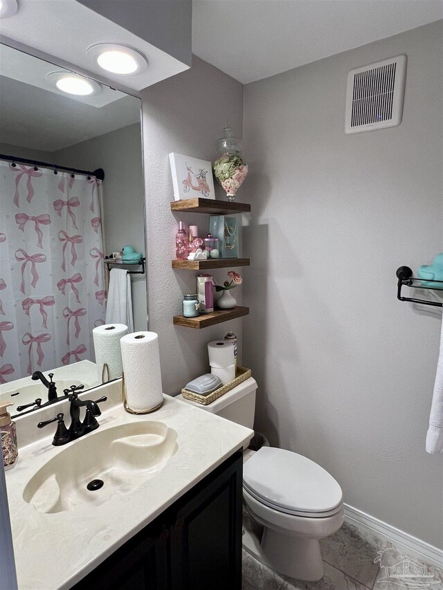 39 Blithewood Dr, Pensacola, FL 32514 - bathroom with toilet, vanity, and baseboards