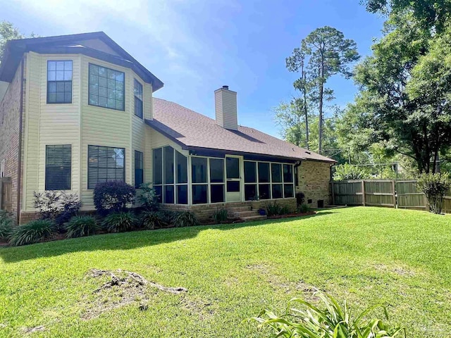 39 Blithewood Dr, Pensacola, FL 32514 - back of property featuring a sunroom, a chimney, brick siding, and a shingled roof