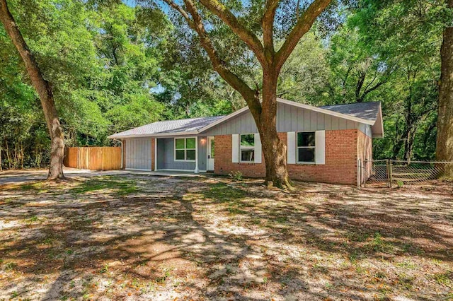 6257 Mohawk Trl, Milton, FL 32583 - view of front of house with fence and brick siding