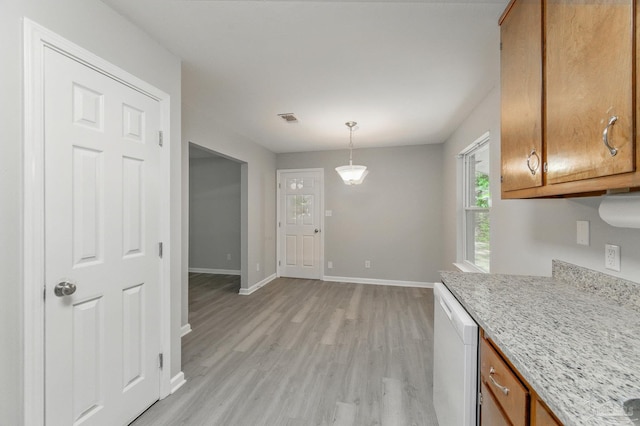 6257 Mohawk Trl, Milton, FL 32583 - kitchen featuring white dishwasher, light wood-style floors, brown cabinetry, baseboards, and decorative light fixtures