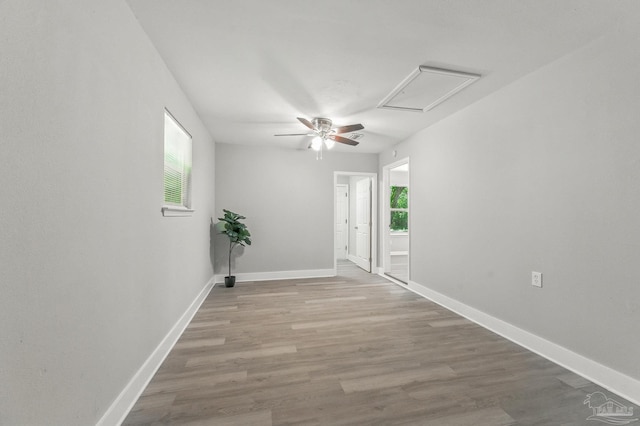 6257 Mohawk Trl, Milton, FL 32583 - unfurnished room with healthy amount of natural light, wood finished floors, attic access, and ceiling fan