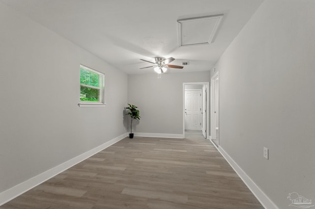 6257 Mohawk Trl, Milton, FL 32583 - unfurnished room featuring attic access, wood finished floors, ceiling fan, and baseboards