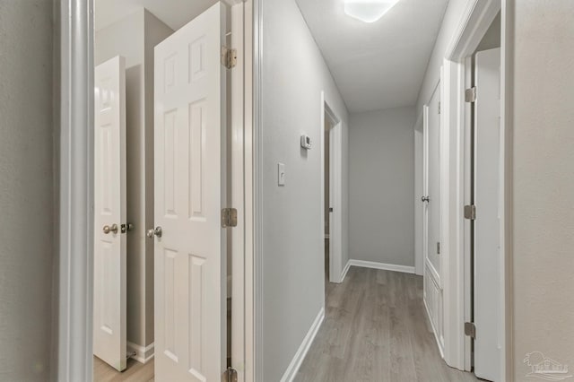 6257 Mohawk Trl, Milton, FL 32583 - corridor with light wood-style flooring and baseboards