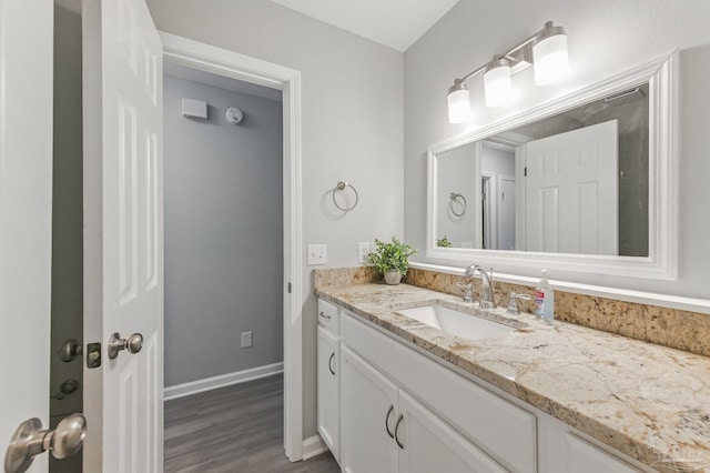 6257 Mohawk Trl, Milton, FL 32583 - bathroom with wood finished floors, vanity, and baseboards