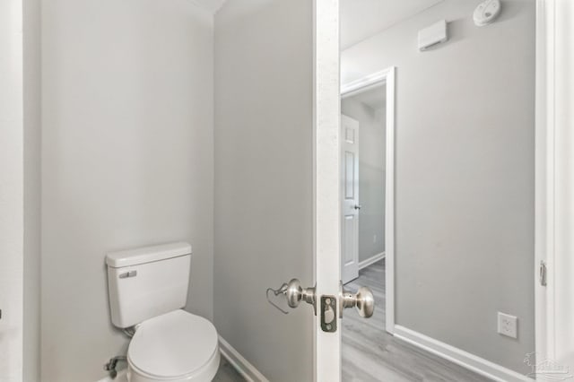 6257 Mohawk Trl, Milton, FL 32583 - bathroom with wood finished floors, baseboards, and toilet