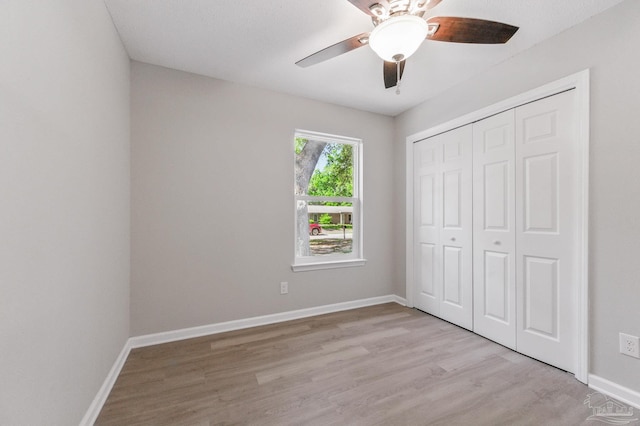 6257 Mohawk Trl, Milton, FL 32583 - unfurnished bedroom featuring light wood-style flooring, baseboards, a closet, and ceiling fan