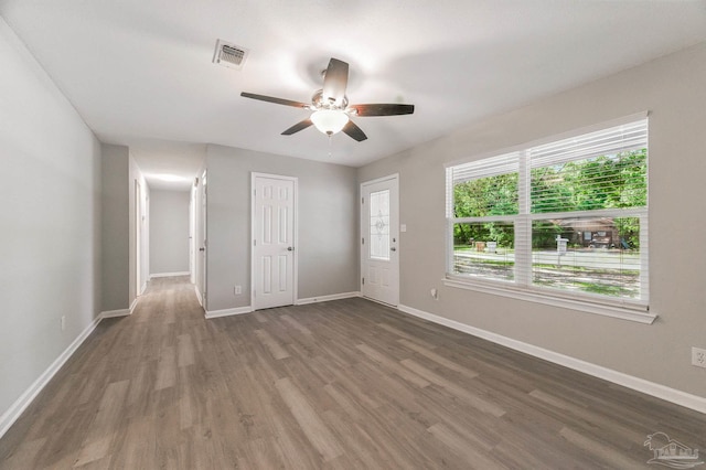 6257 Mohawk Trl, Milton, FL 32583 - unfurnished bedroom featuring wood finished floors, baseboards, a ceiling fan, and a closet