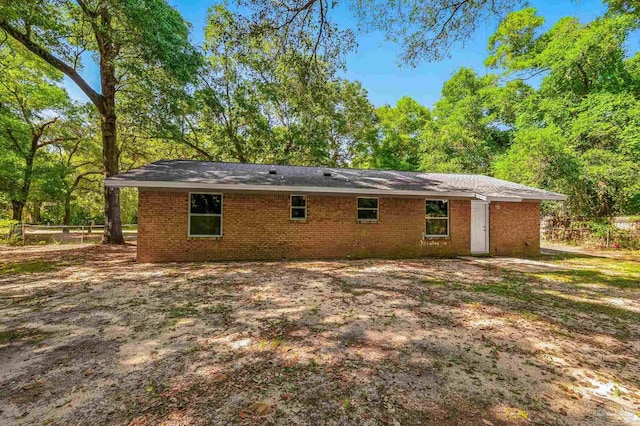 6257 Mohawk Trl, Milton, FL 32583 - back of house with brick siding and fence