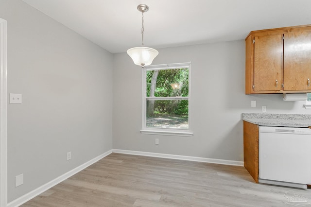 6257 Mohawk Trl, Milton, FL 32583 - kitchen featuring white dishwasher, light wood-style floors, light countertops, baseboards, and hanging light fixtures