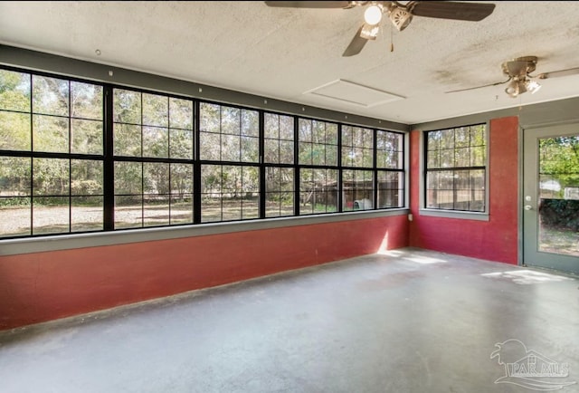 unfurnished sunroom with a ceiling fan