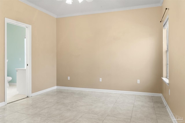 empty room featuring light tile patterned flooring, crown molding, and baseboards