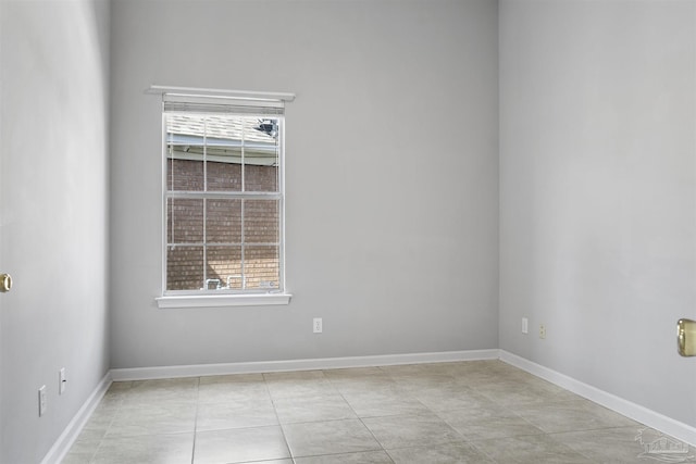 spare room with baseboards