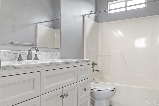 full bath with toilet, shower / washtub combination, and vanity