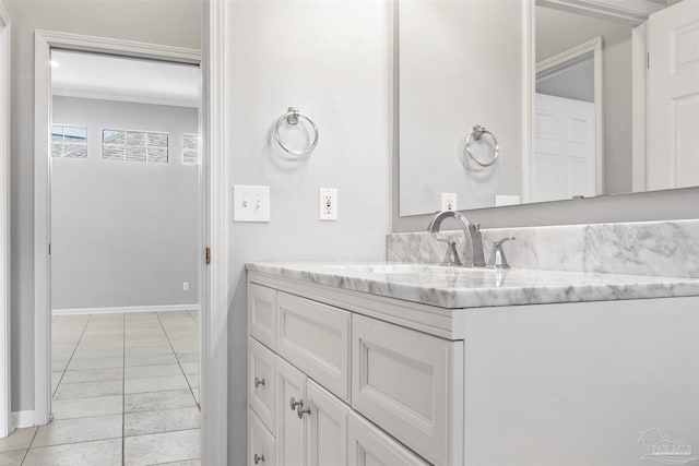 bathroom featuring tile patterned flooring, vanity, and baseboards