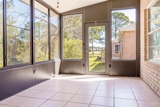 unfurnished sunroom featuring lofted ceiling