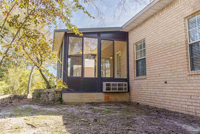 view of home's exterior with a sunroom