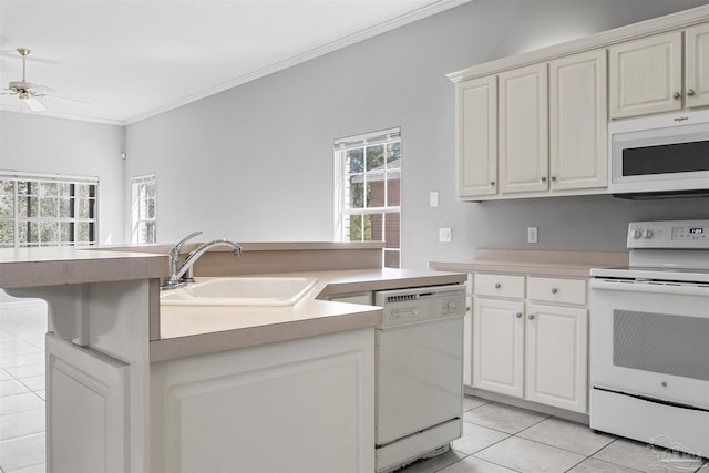 kitchen featuring light tile patterned floors, ornamental molding, a ceiling fan, a sink, and white appliances