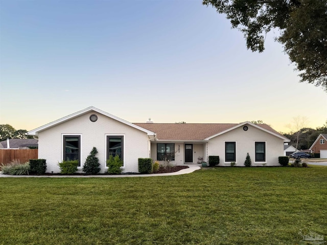 ranch-style house with a yard