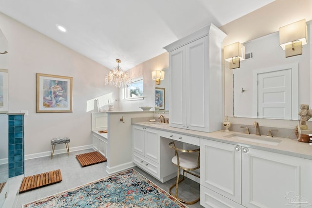 bathroom with lofted ceiling, vanity, a bathing tub, and an inviting chandelier