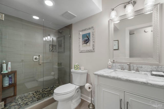 bathroom featuring toilet, vanity, walk in shower, and hardwood / wood-style flooring