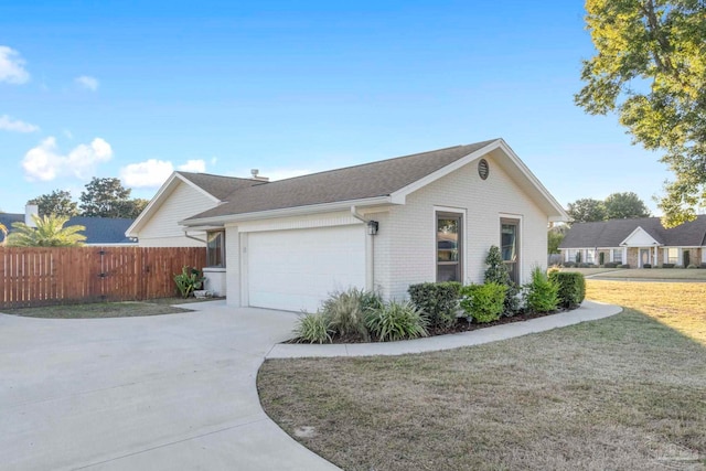 view of side of property featuring a garage and a lawn