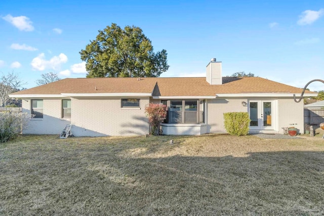 back of property featuring french doors and a yard