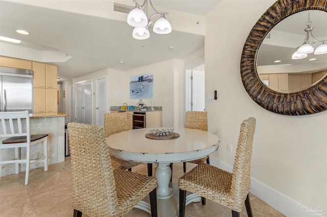 dining space with wine cooler, an inviting chandelier, and light tile patterned flooring