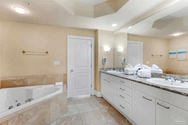 bathroom with vanity and tiled bath