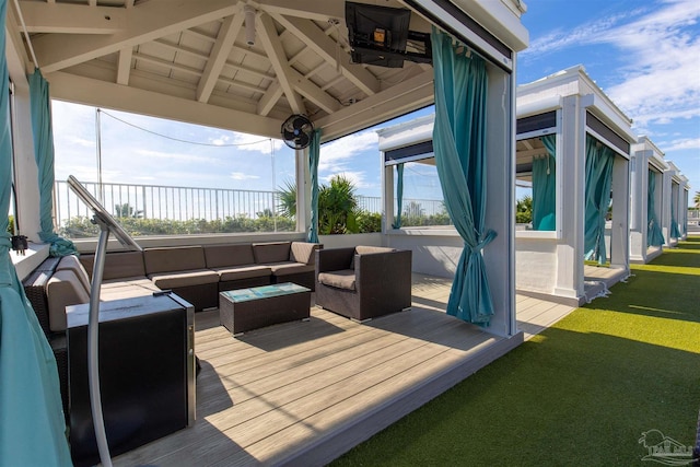 wooden terrace featuring outdoor lounge area, a gazebo, and a yard