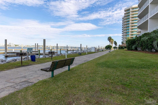 view of community featuring a yard and a water view