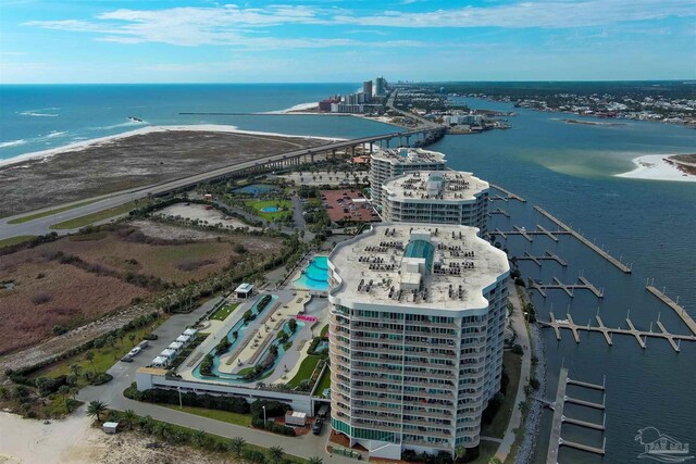 drone / aerial view featuring a beach view and a water view