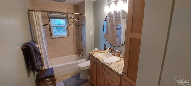 full bathroom featuring tiled shower / bath combo, vanity, and toilet