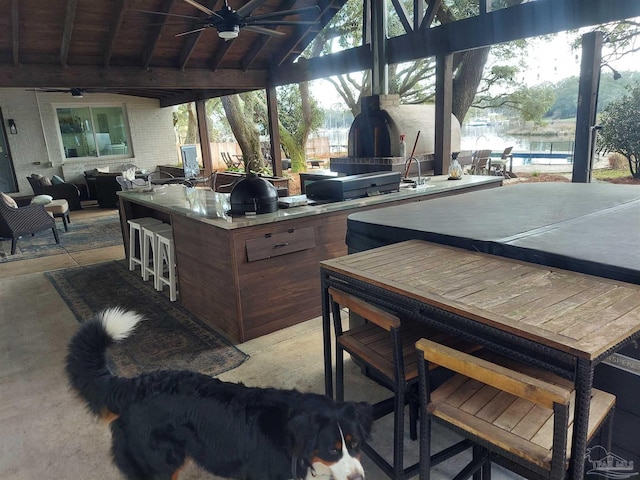 view of patio with area for grilling, a gazebo, an outdoor bar, and ceiling fan