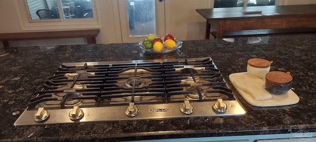 interior details with stainless steel gas cooktop and white cabinets