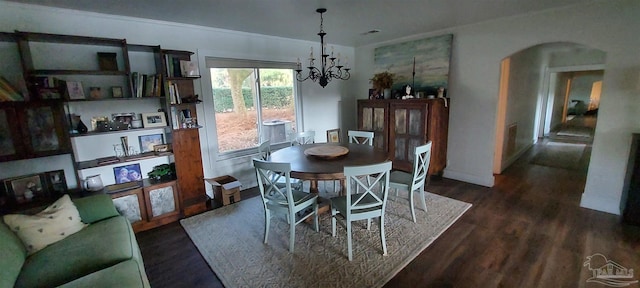 dining room with an inviting chandelier and dark hardwood / wood-style floors