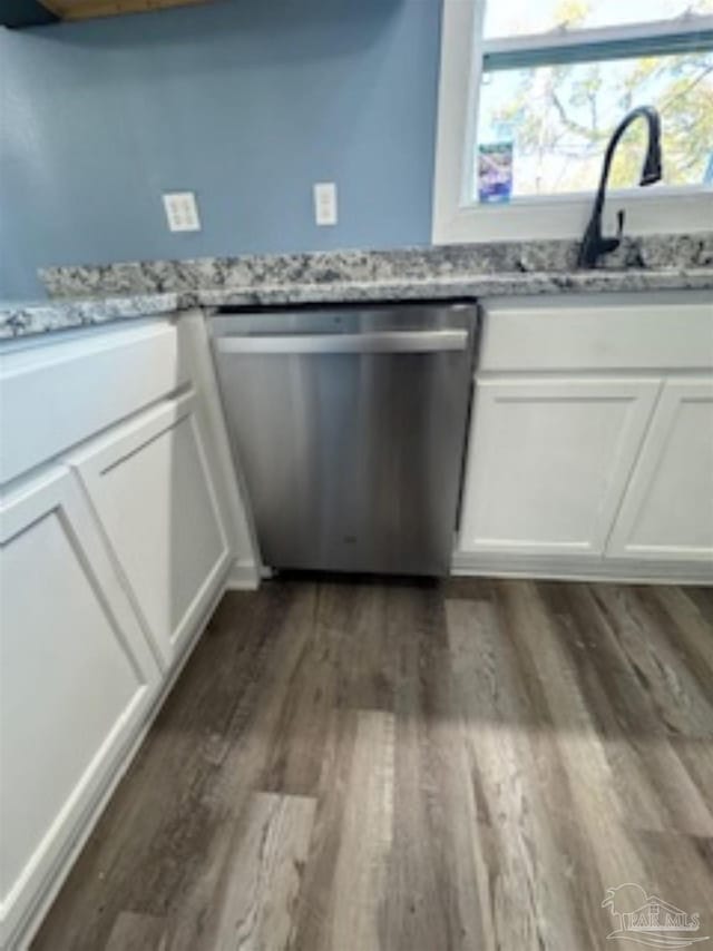 kitchen featuring white cabinets, dark hardwood / wood-style floors, a healthy amount of sunlight, and stainless steel dishwasher