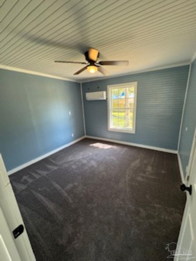 carpeted spare room featuring an AC wall unit and ceiling fan