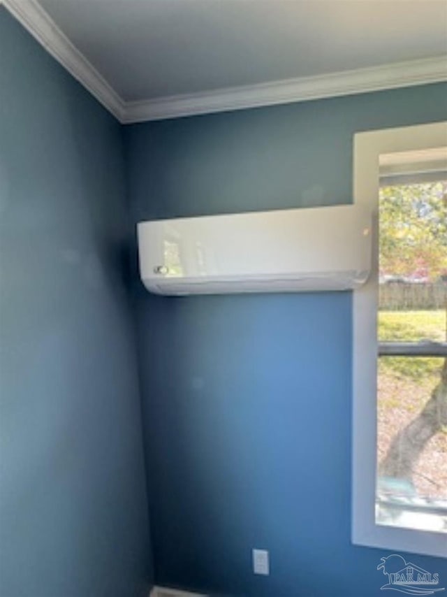 interior details featuring crown molding and a wall unit AC